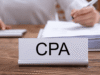 How AI Is Changing the CPA Industry in 2026 Close-up of a CPA nameplate on a desk with a stack of papers and a person writing in the background.