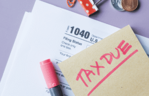 IRS Tax Updates 2026: What US Business Owners & Individuals Must Know Tax form 1040 with a pink 'TAX DUE' stamp on a beige note and a pink marker on a lavender background