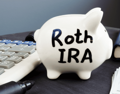 Roth Conversion Strategy 2026: How High-Income Earners Can Save on Taxes White piggy bank labeled Roth IRA on a desk next to a calculator, pen, wallet, and stacks of cash—conveys retirement savings.